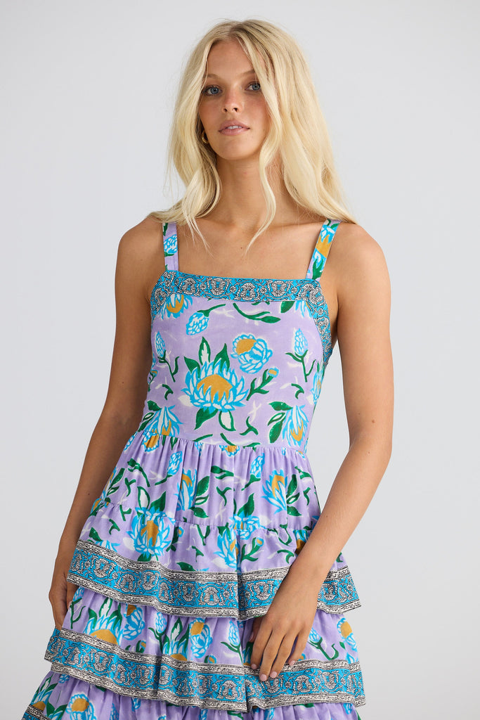 Woman wearing a floral dress with a white background