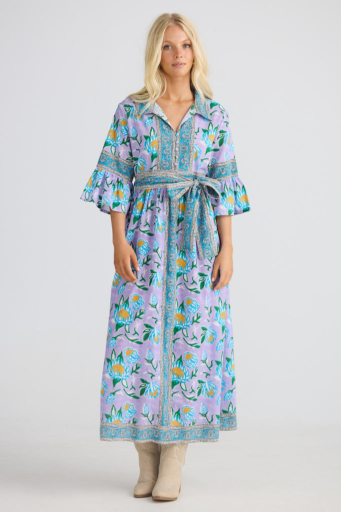 Woman wearing a floral dress on a white background