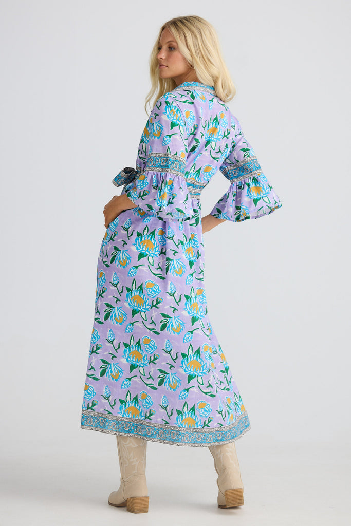 Woman wearing a floral dress with a white background