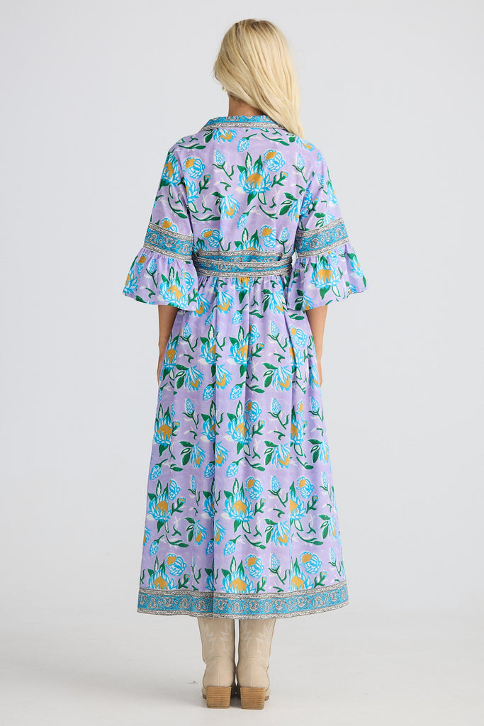 Woman wearing a floral dress with a white background