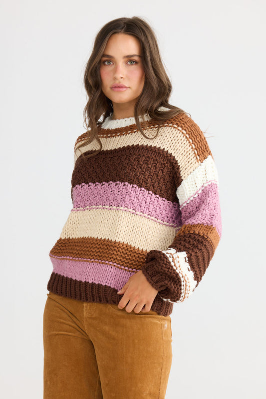 Model wearing Hudson Knit in brown multi with ribbed crew neckline and long sleeves, back view on white background