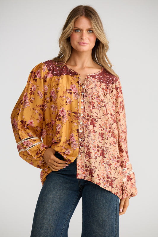 Woman wearing a floral blouse with a plain background