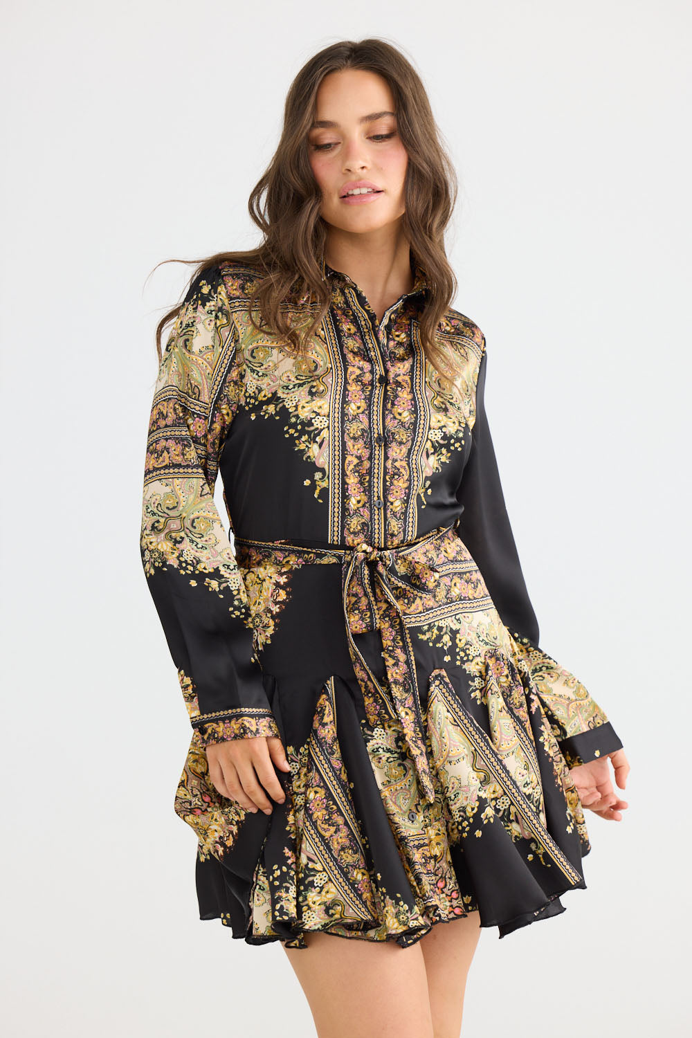 Model wearing Clove Dress in black paisley with classic two-piece collar, front view on white background