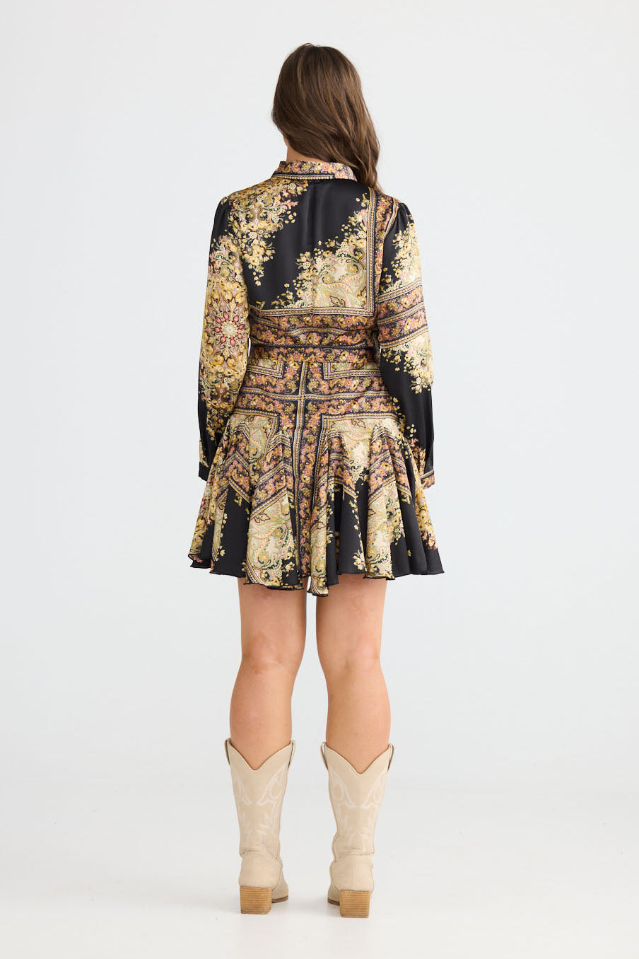 Model wearing Clove Dress in black paisley with classic two-piece collar, side view on white background