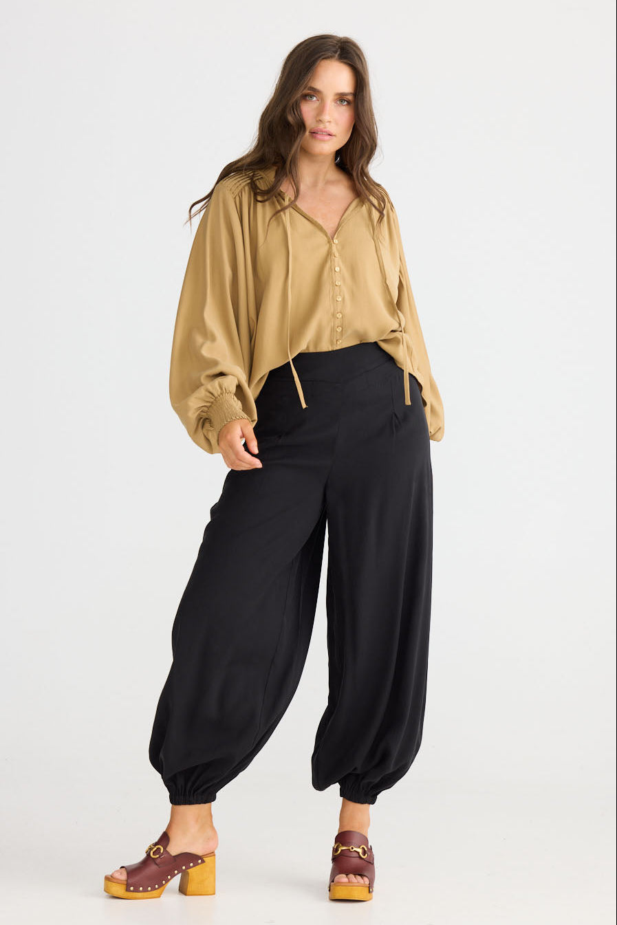 Close-up of Genie Pant in black showing elasticated back waistband, detail view on white background
