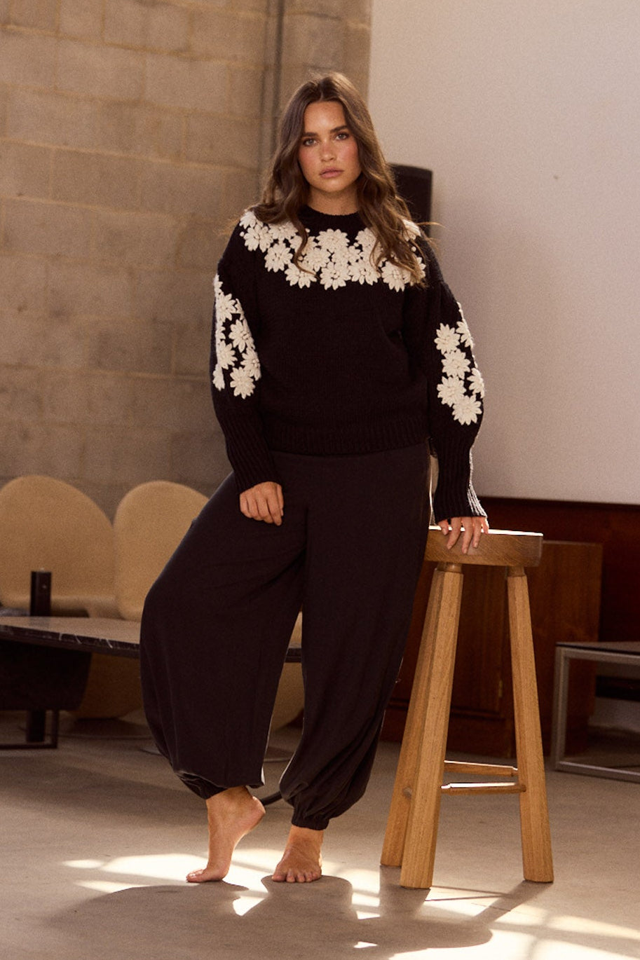 Model wearing Genie Pant in black with elasticated back waistband, back view on white background