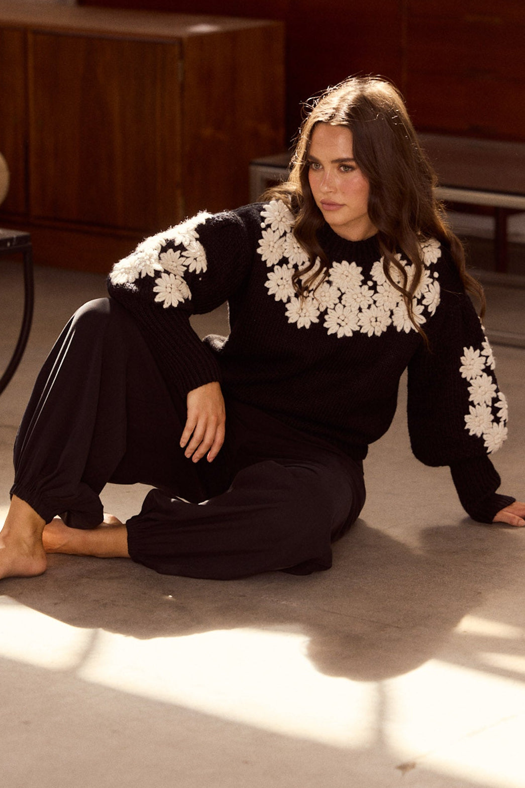 Model wearing Genie Pant in black with elasticated back waistband, side view on white background