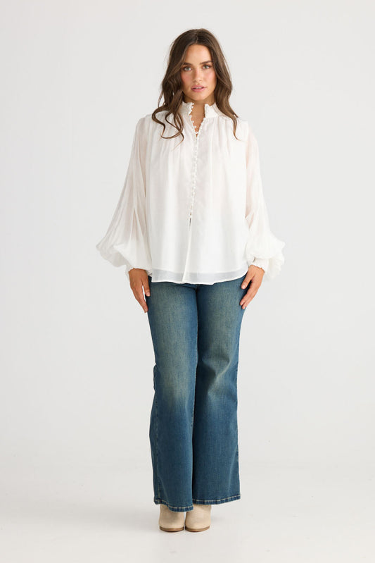 Close-up of Sylva Blouse in off white showing high collar with ruched details, detail view on white background
