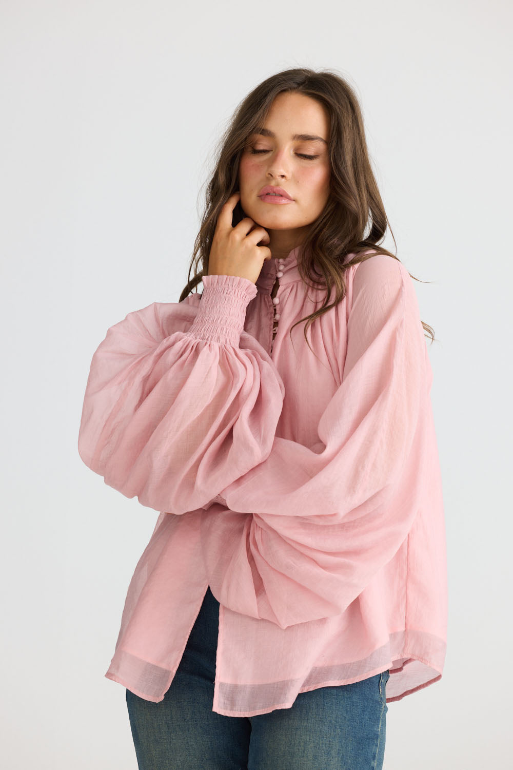 Close-up of Sylva Blouse in pink showing high collar with ruched details, detail view on white background