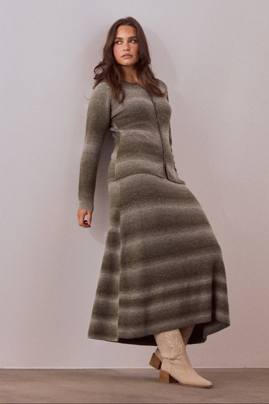 Model wearing Essence Knit Top in moss ombre with ombre knit design and long sleeves, side view on white background