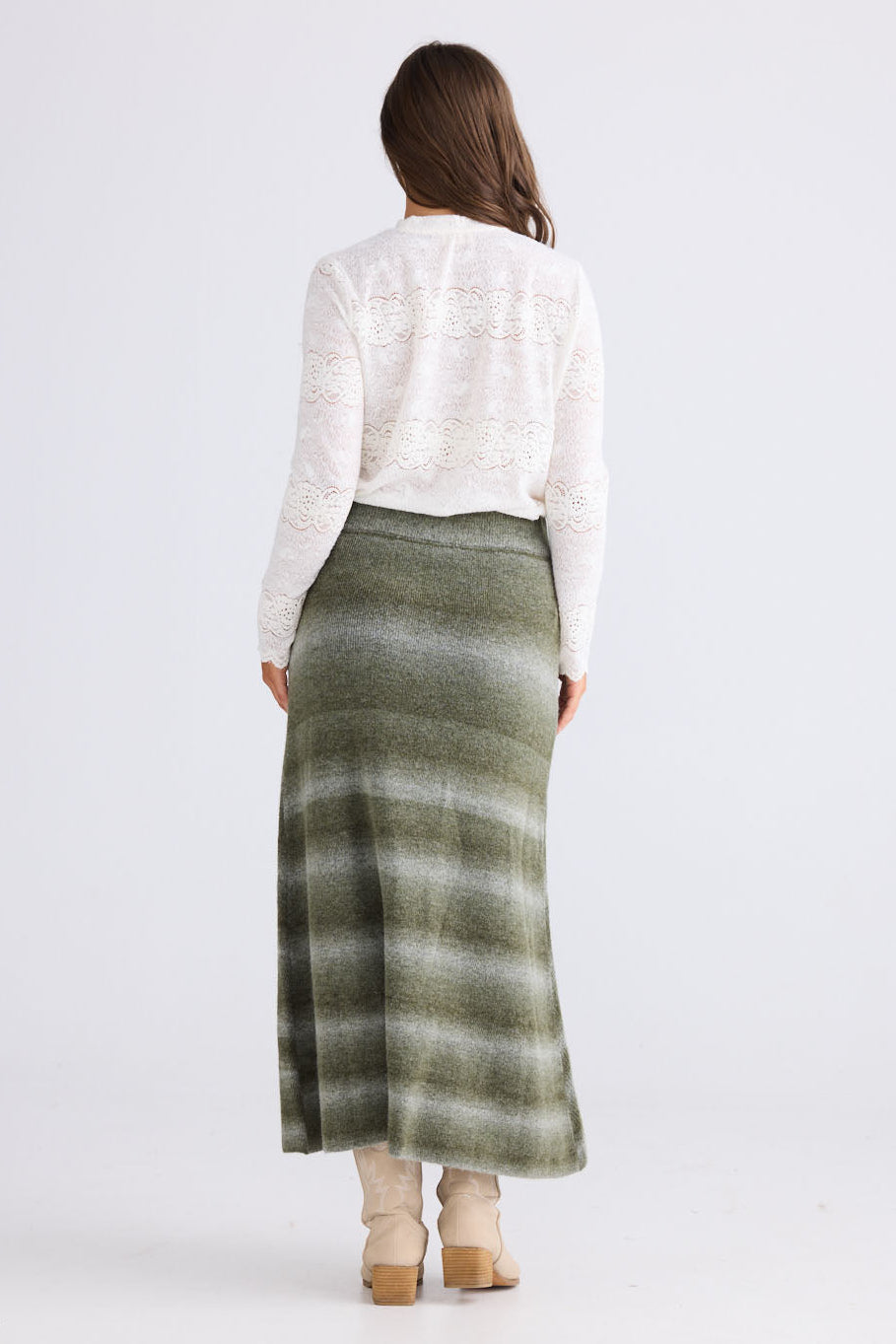 Model wearing Essence Knit Skirt in moss ombre with ombre knit design, side view on white background