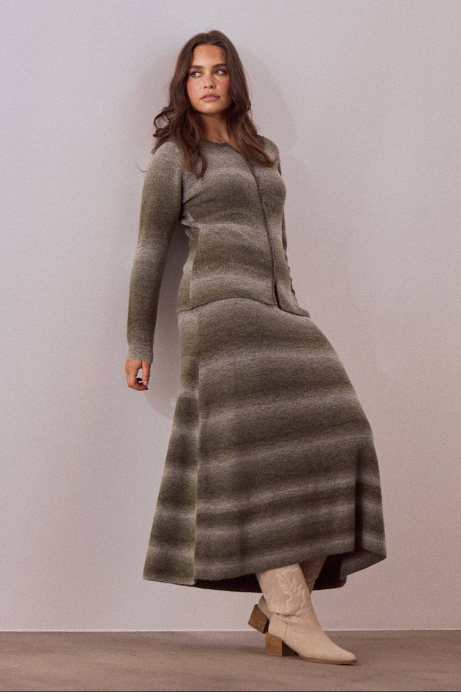 Model wearing Essence Knit Skirt in moss ombre with ombre knit design, front view on white background