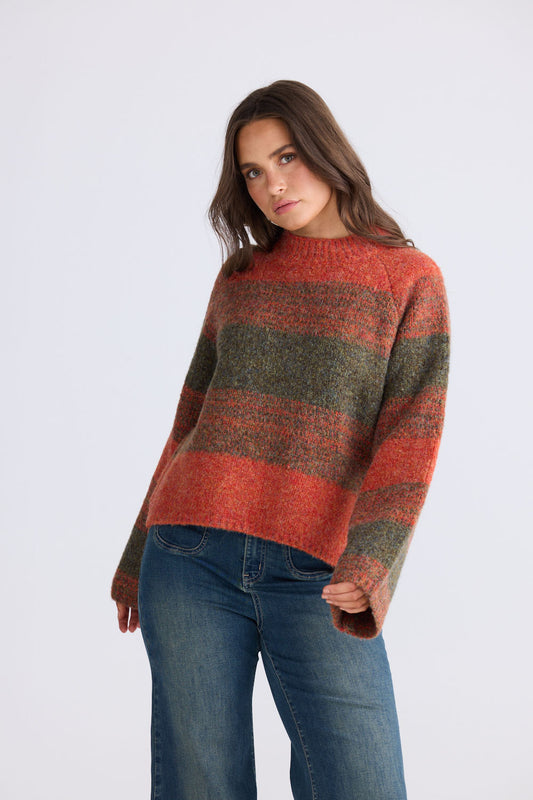 Model wearing Vesper Knit in orange and green with wide long sleeves and side splits, back view on white background
