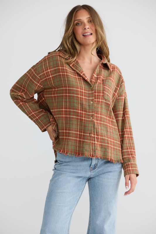 Model wearing Daytona Shirt in rust check with two-piece collar and long sleeves, front view on white background