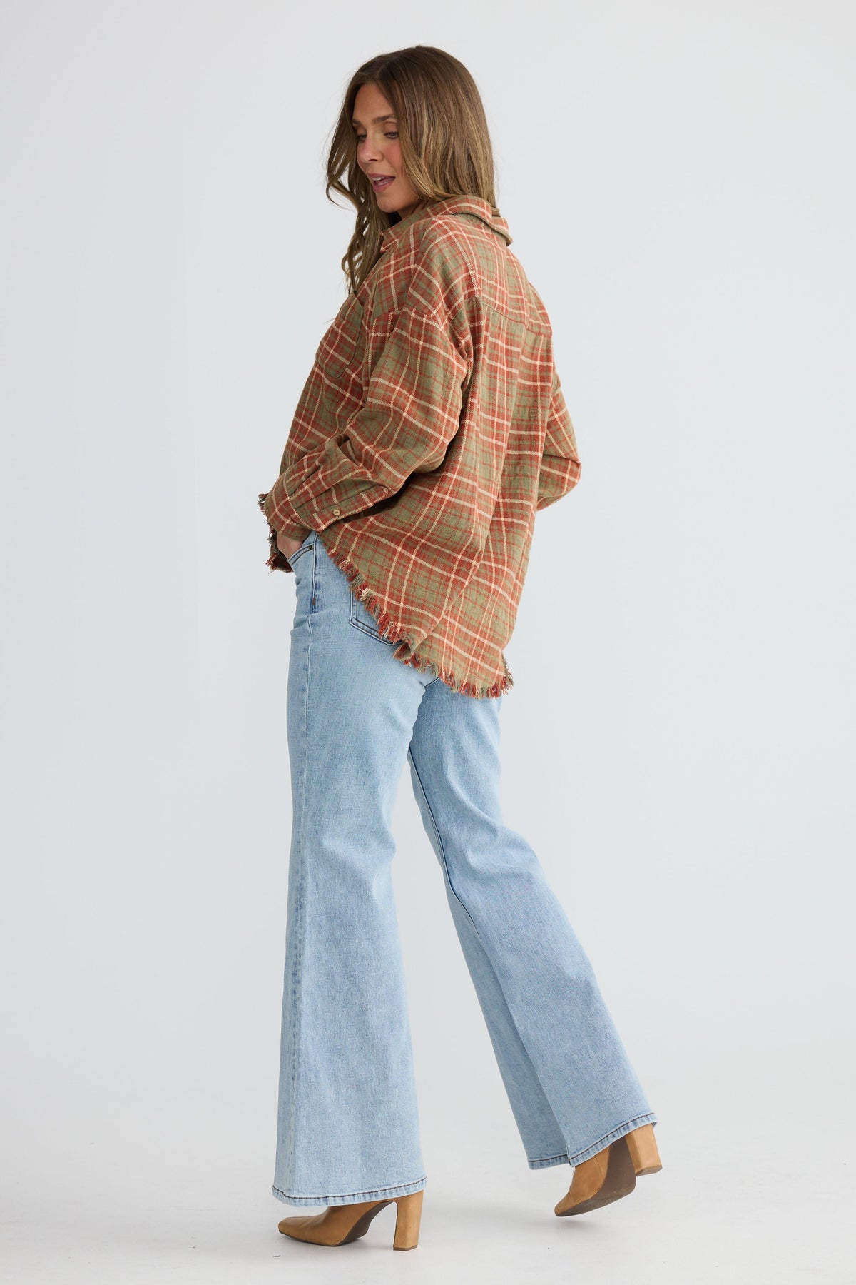 Close-up of Daytona Shirt in rust check showing two-piece collar and long sleeves, detail view on white background