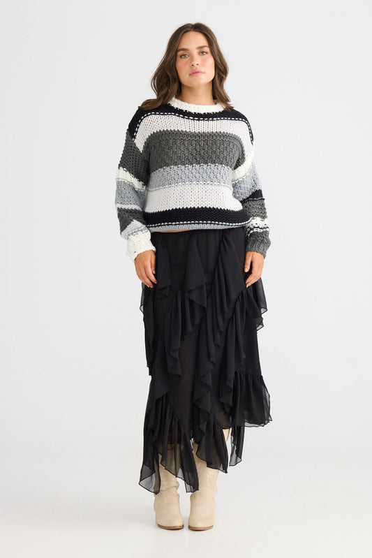 Model wearing Rafael Skirt in black with elasticated waist, front view on white background
