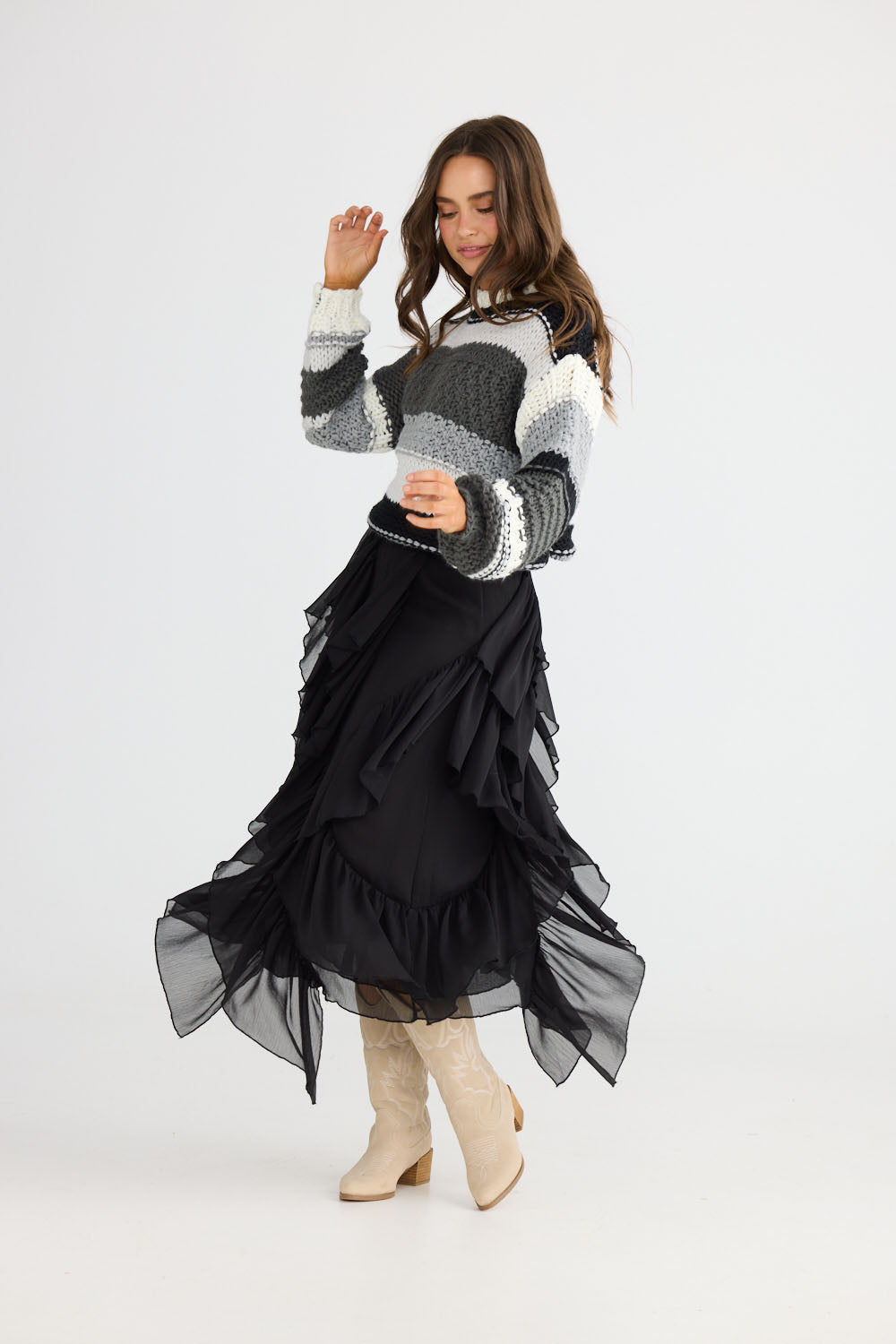 Model wearing Rafael Skirt in black with elasticated waist, front view on white background
