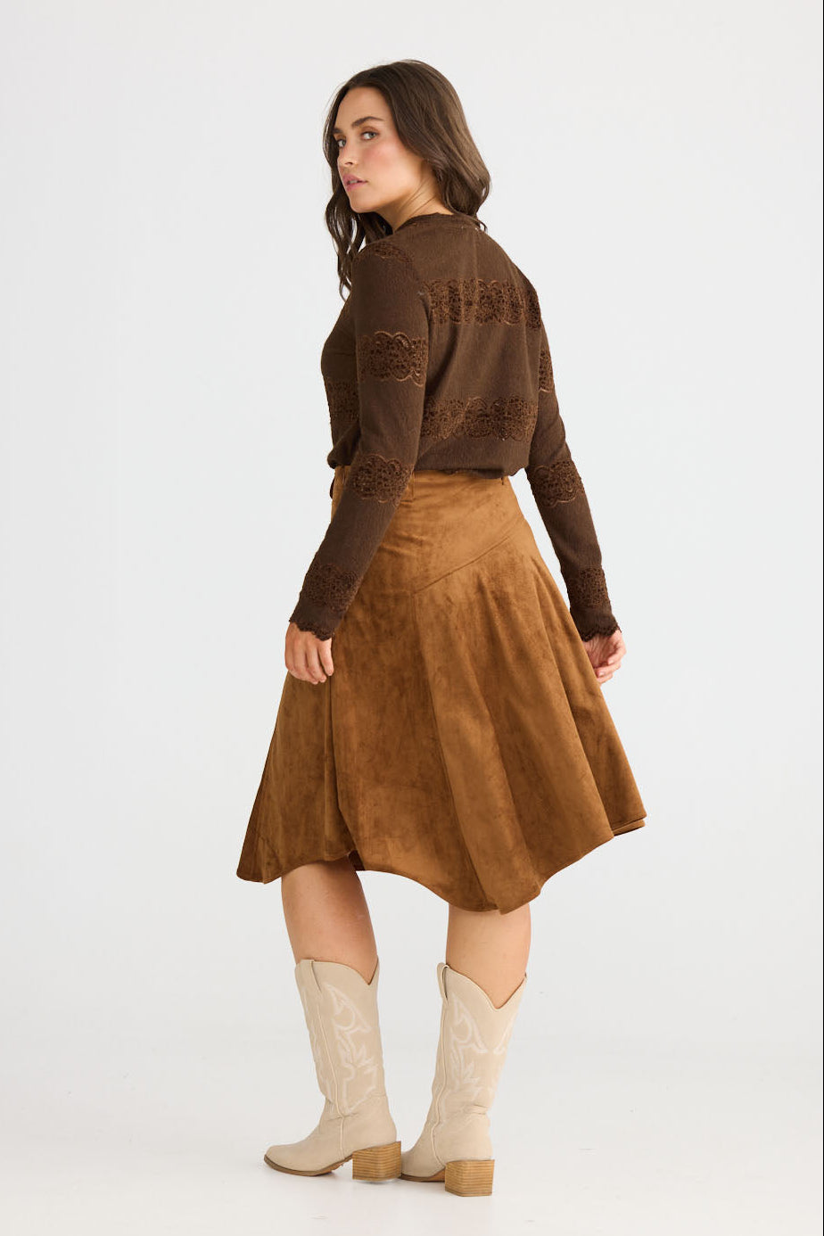 Model wearing Runa Skirt in chocolate with natural waist fit, back view on white background