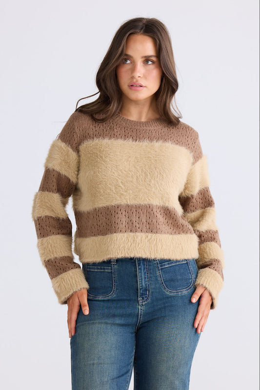 Model wearing Kyoko Knit in mocha and taupe with ribbed neckline and long sleeves, front view on white background
