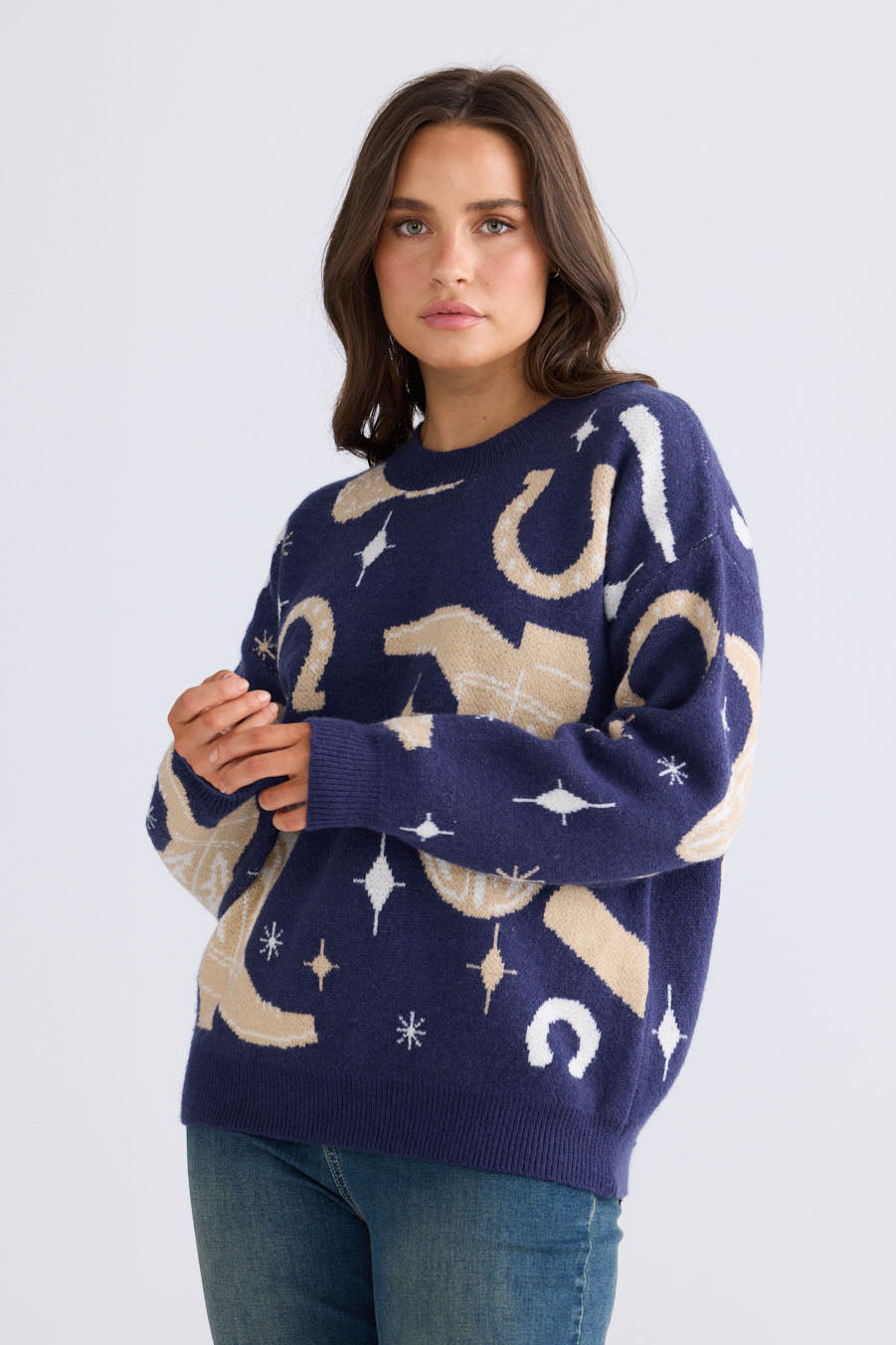 Close-up of Lucky Boots Knit in navy showing ribbed neckline and cowboy-themed print, detail view on white background