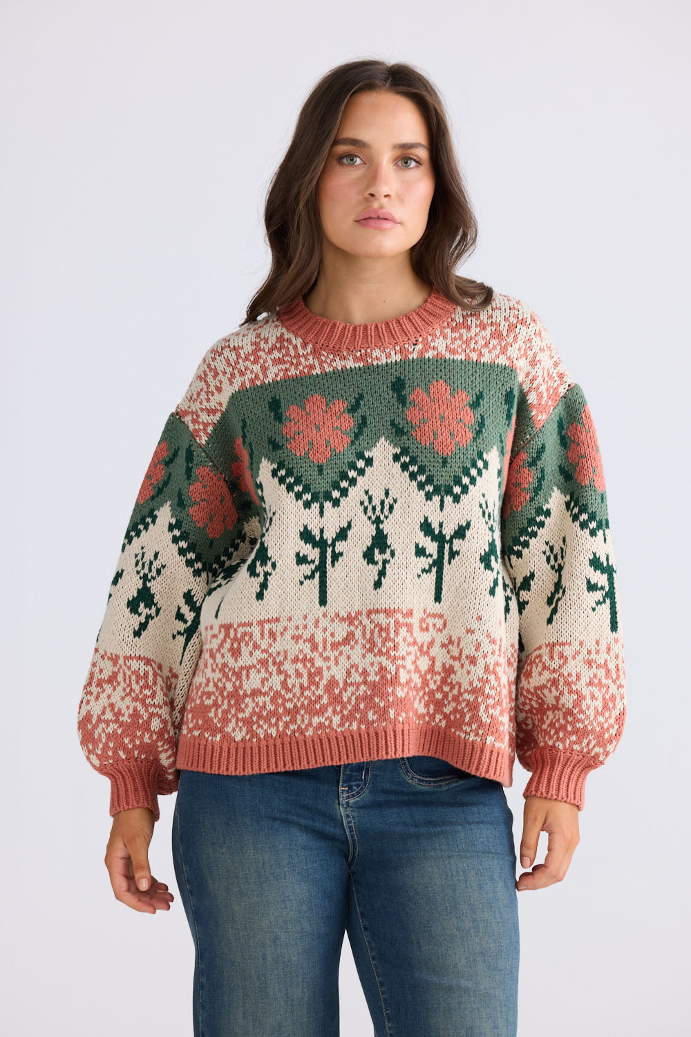 Close-up of Cottage Knit in terracotta and green showing ribbed neckline, detail view on white background
