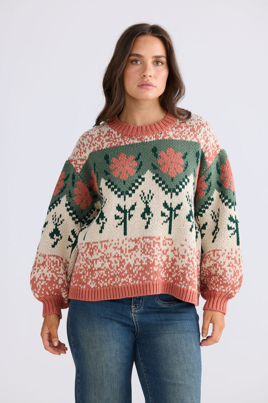 Close-up of Cottage Knit in terracotta and green showing ribbed neckline, detail view on white background