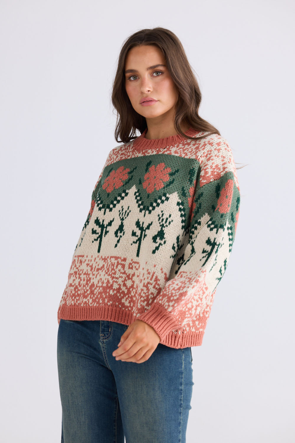 Model wearing Cottage Knit in terracotta and green with ribbed neckline and dropped shoulder, back view on white background