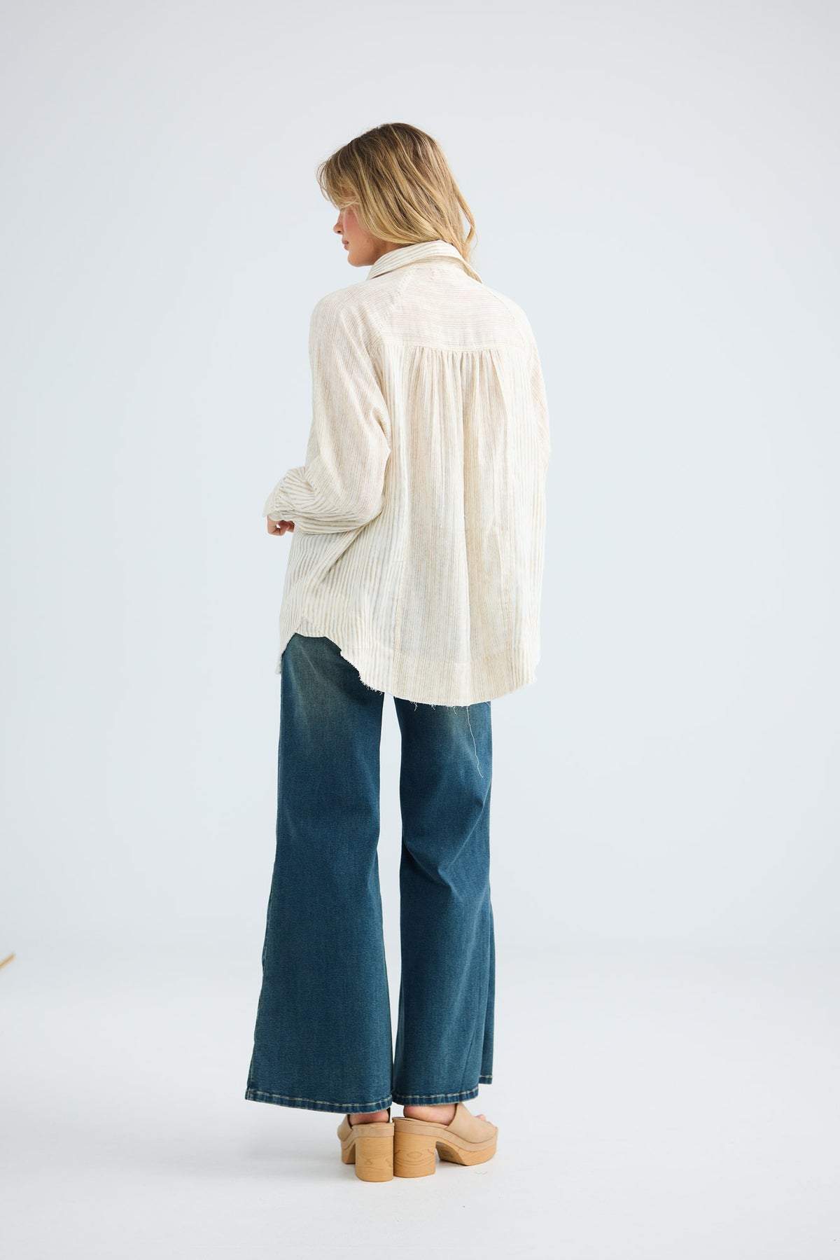 Bodhi Shirt in natural stripe, back view showing the relaxed drop-shoulder fit.