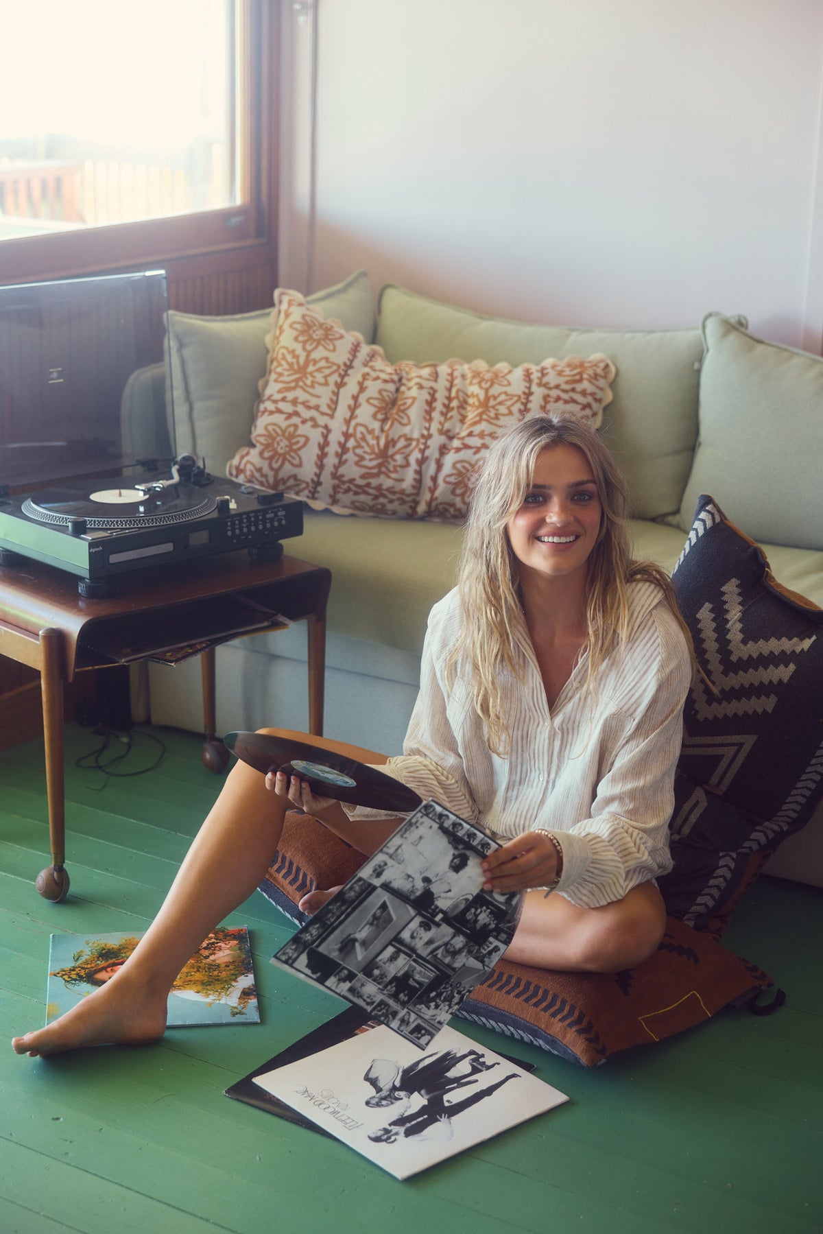 Bodhi Shirt in natural stripe, lounging on the floor at home.