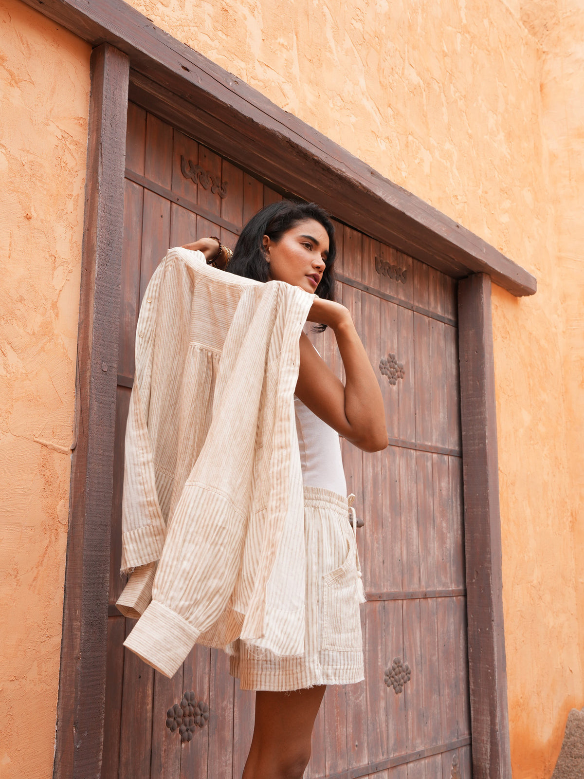 Bodhi Shirt in natural stripe slung over the shoulder, with the matching Bodhi Short.