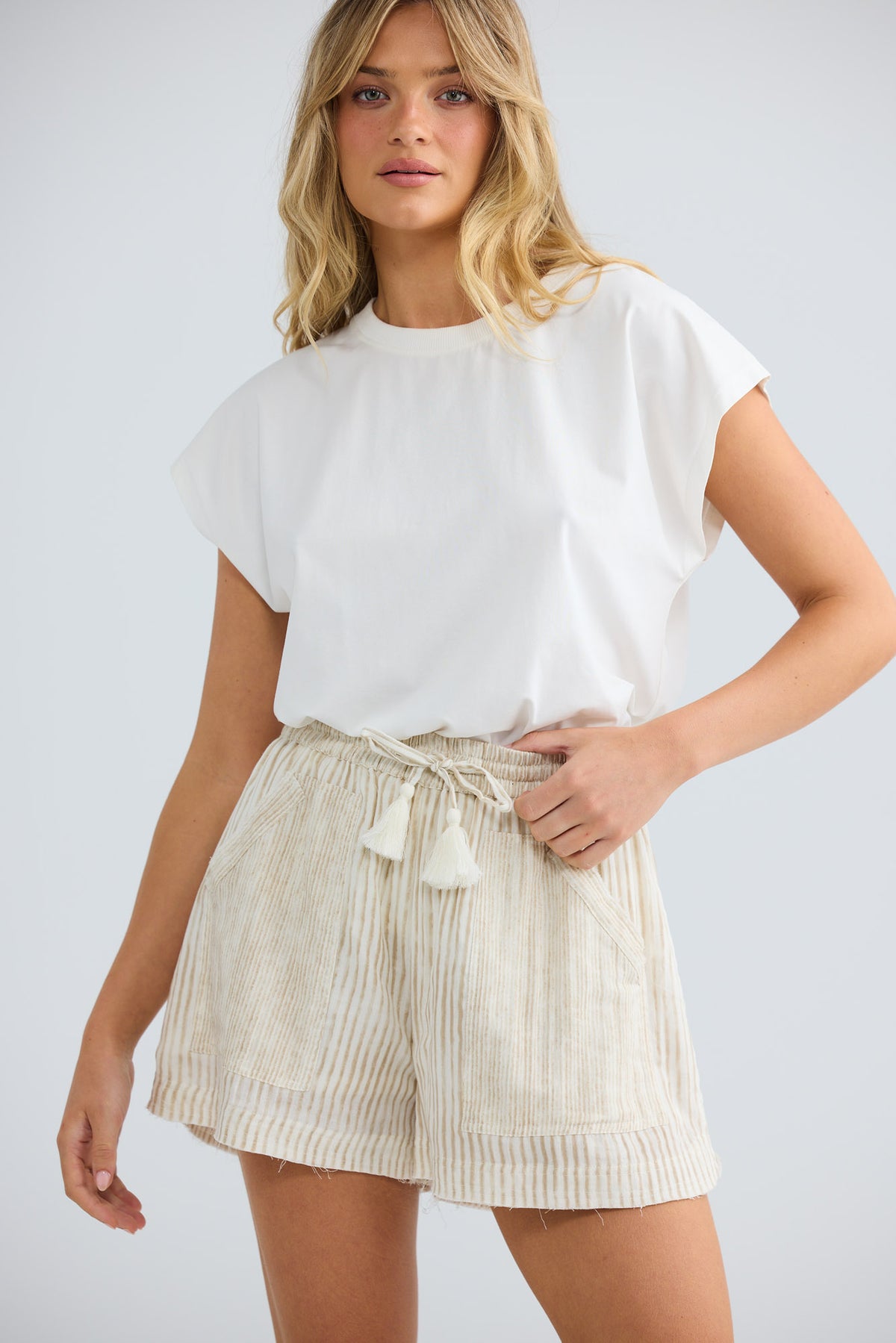 Model wearing Bodhi Short in natural stripe, front view.