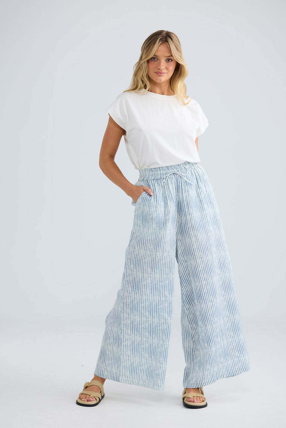 Freedom Pant in blue stripe, relaxed front view with hand in pocket.