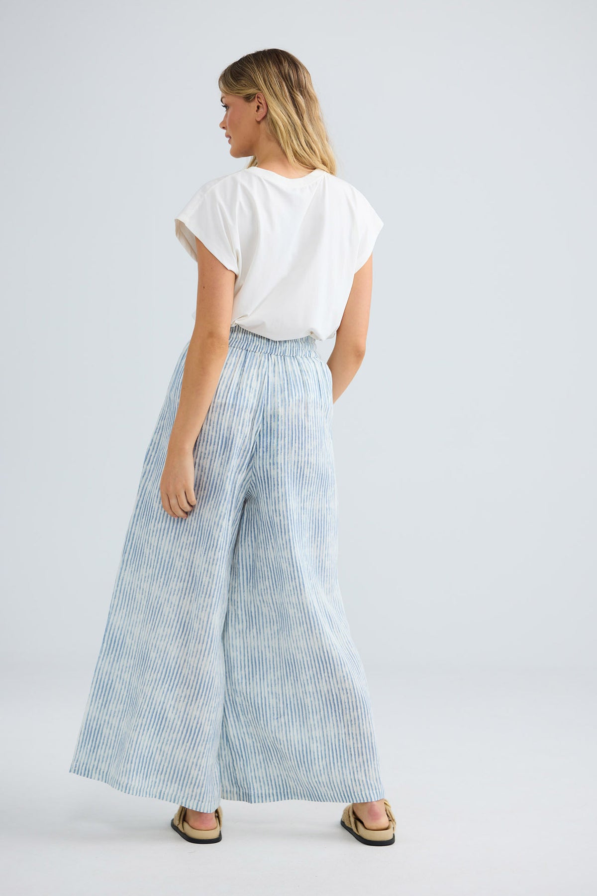 Freedom Pant in blue stripe, side view showing the flowing wide leg.