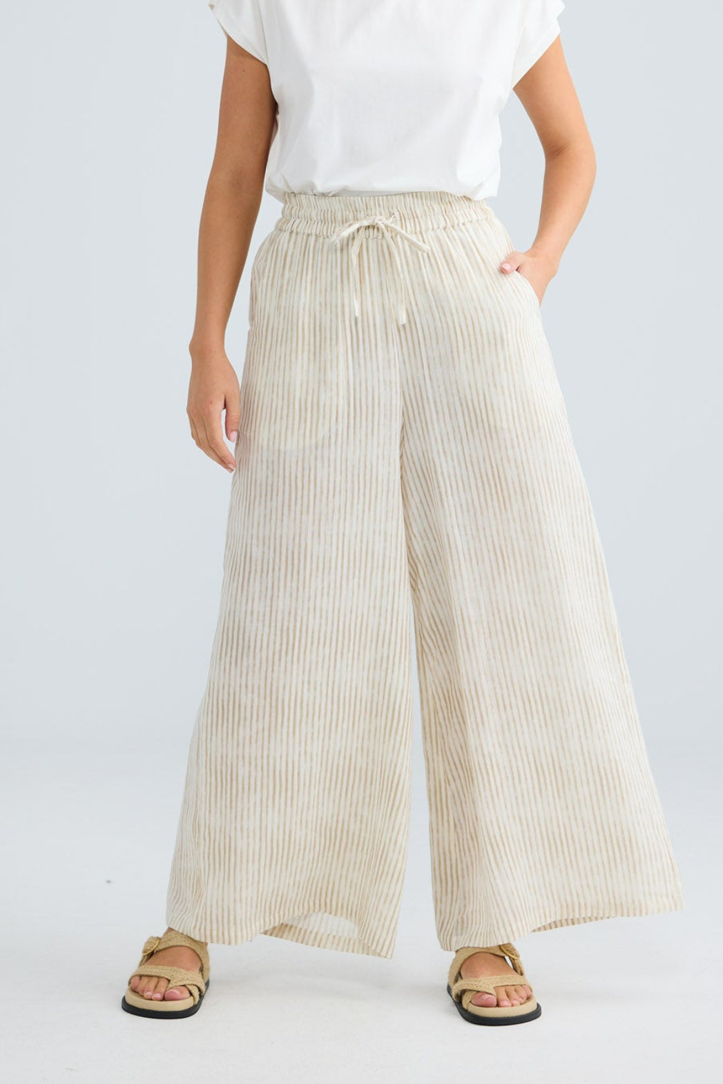 Freedom Pant in natural stripe, close-up of the drawstring tie waist and wide leg.