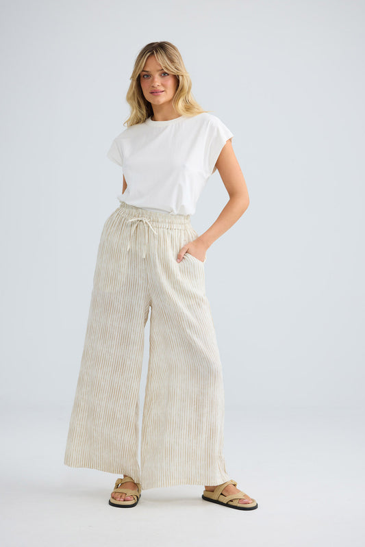 Freedom Pant in natural stripe, front view with hand in pocket.