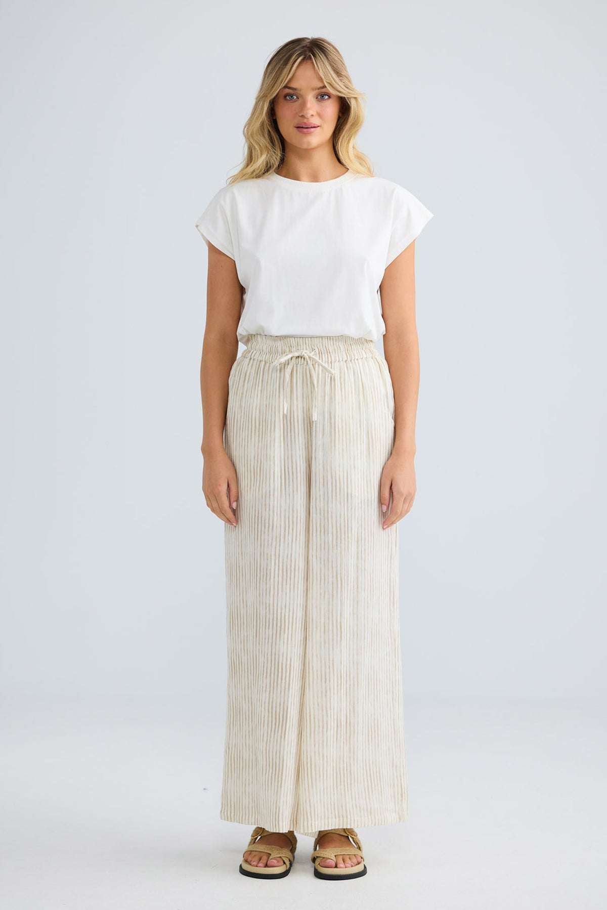Freedom Pant in natural stripe, front view styled with a white tee.