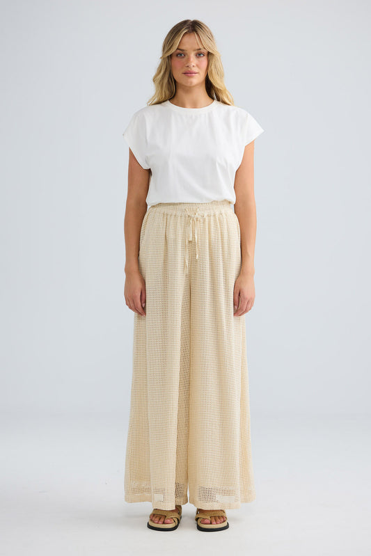 Model wearing Freedom Pant in natural, front view.