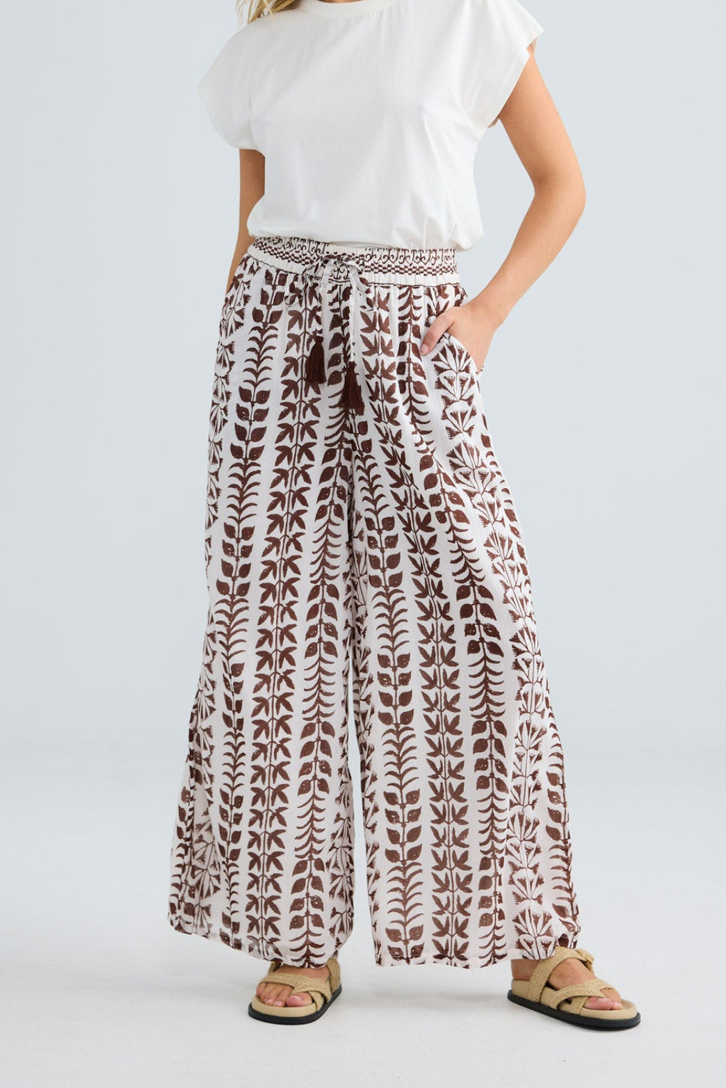 Model wearing Freedom Pant in chocolate paro, front view.