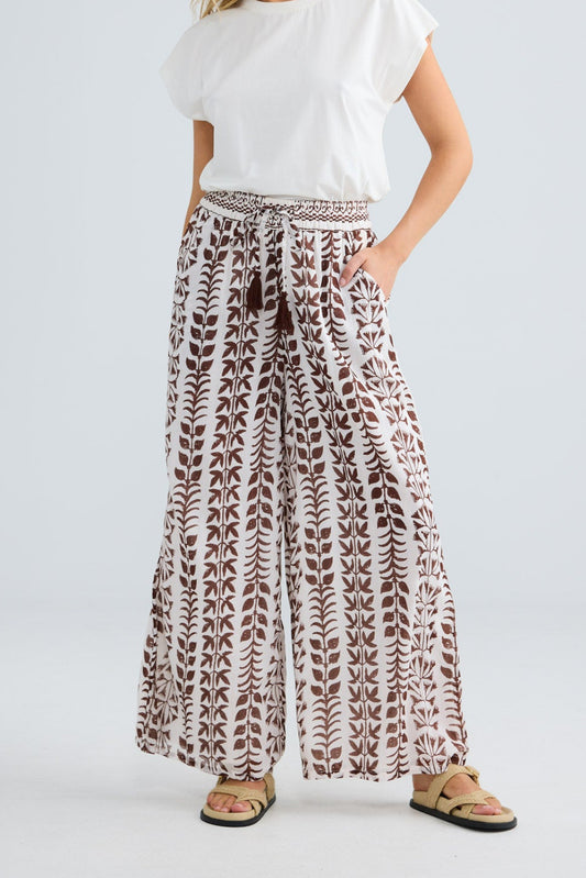 Model wearing Freedom Pant in chocolate paro, front view.