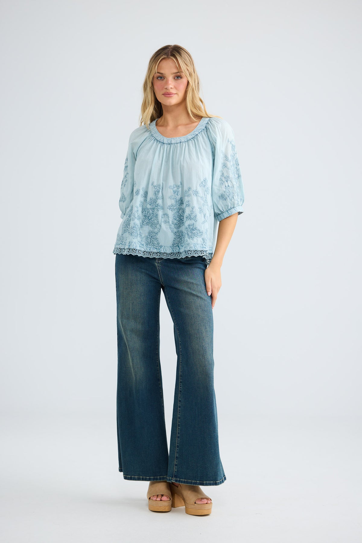 Model wearing Thistle Top in powder blue, front view.