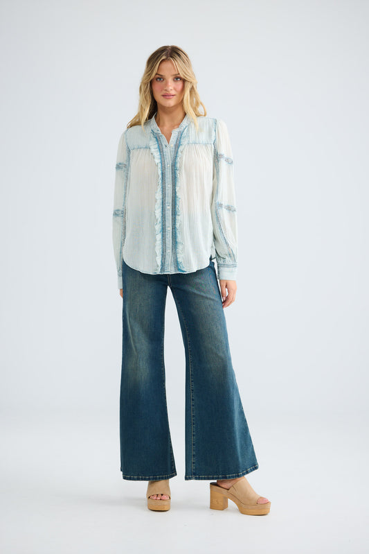Amira Shirt in powder blue, full-length front view styled with wide-leg denim.