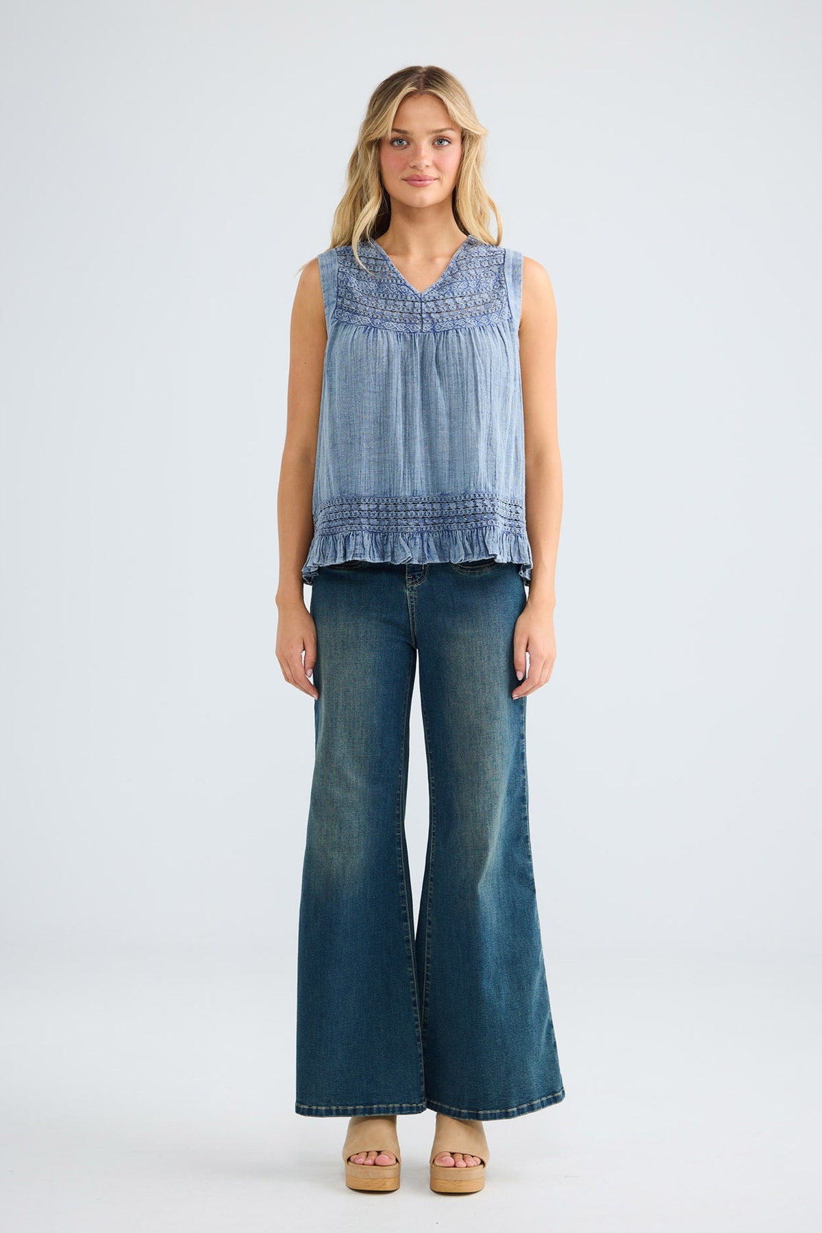 Freesia Top in steel blue, front view showing the frilled hem.