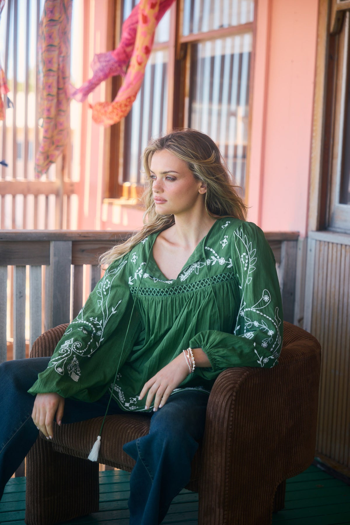 Sapphire Top in olive, relaxed on a porch chair.
