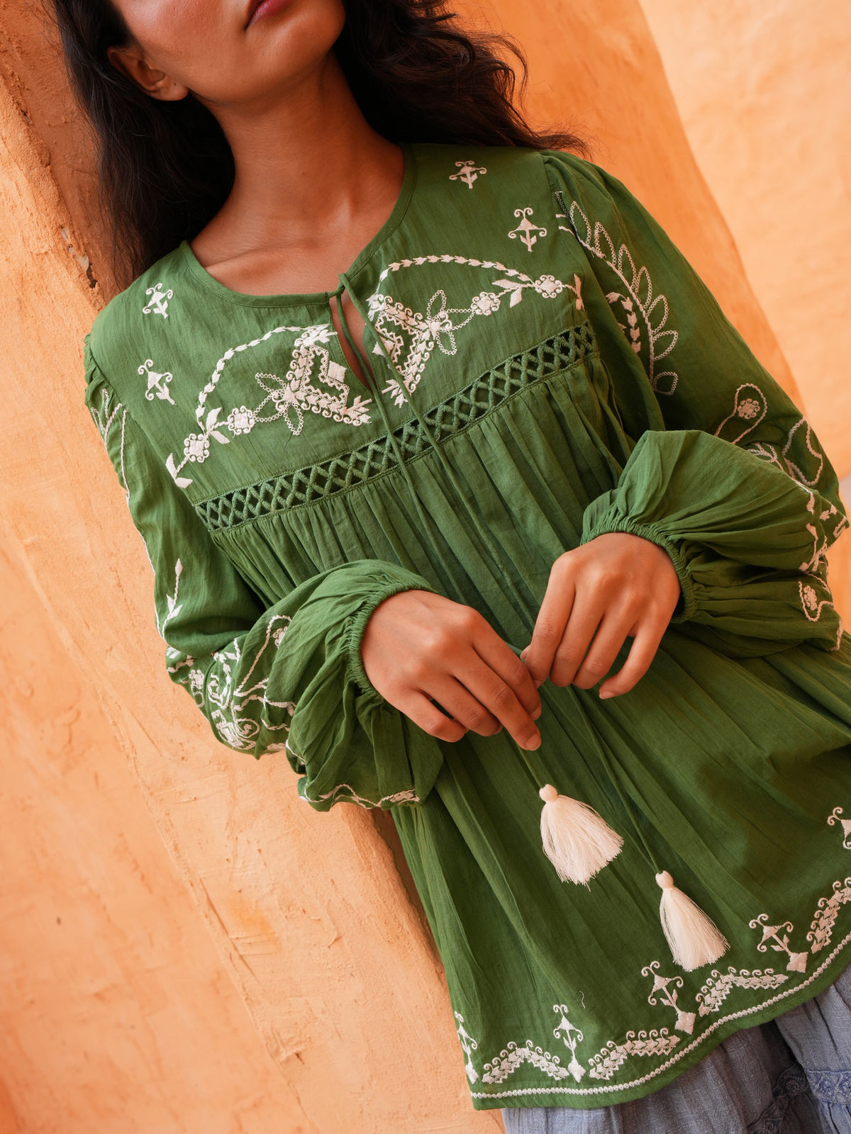 Sapphire Top in olive, close-up of the white embroidery and tassel ties.
