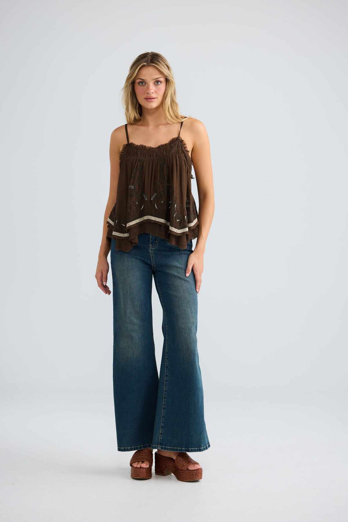 Ambrosia Top in cocoa embroidery, full-length front view with wide-leg denim.