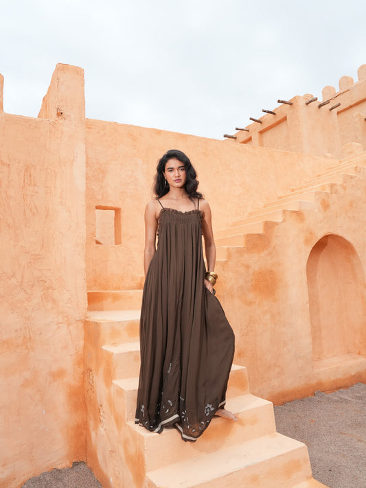Ambrosia Maxi Dress in cocoa, full length on terracotta steps.