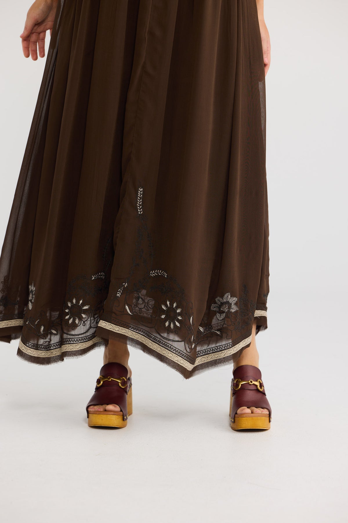 Ambrosia Maxi Dress in cocoa, close-up of the embroidered handkerchief hem.