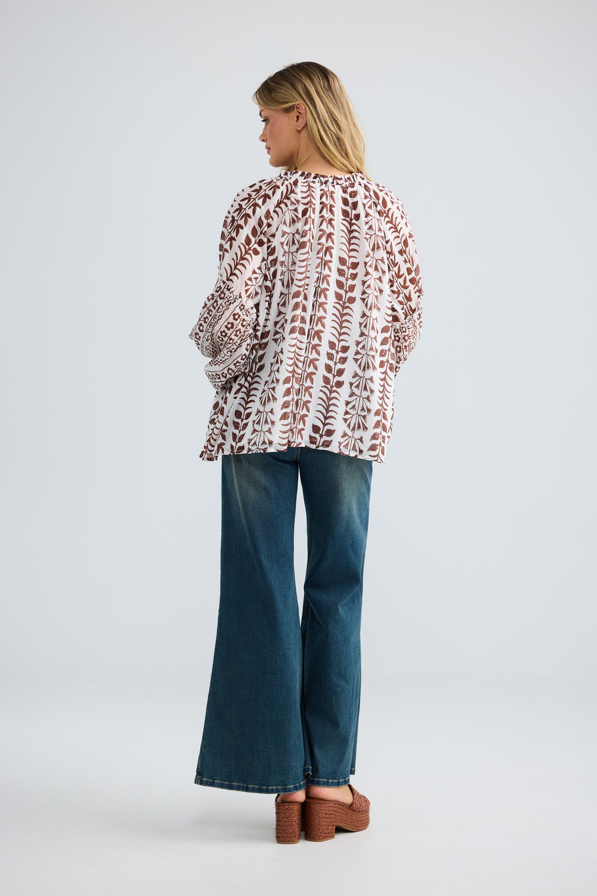 Model wearing Alegria Top in chocolate paro, front view.