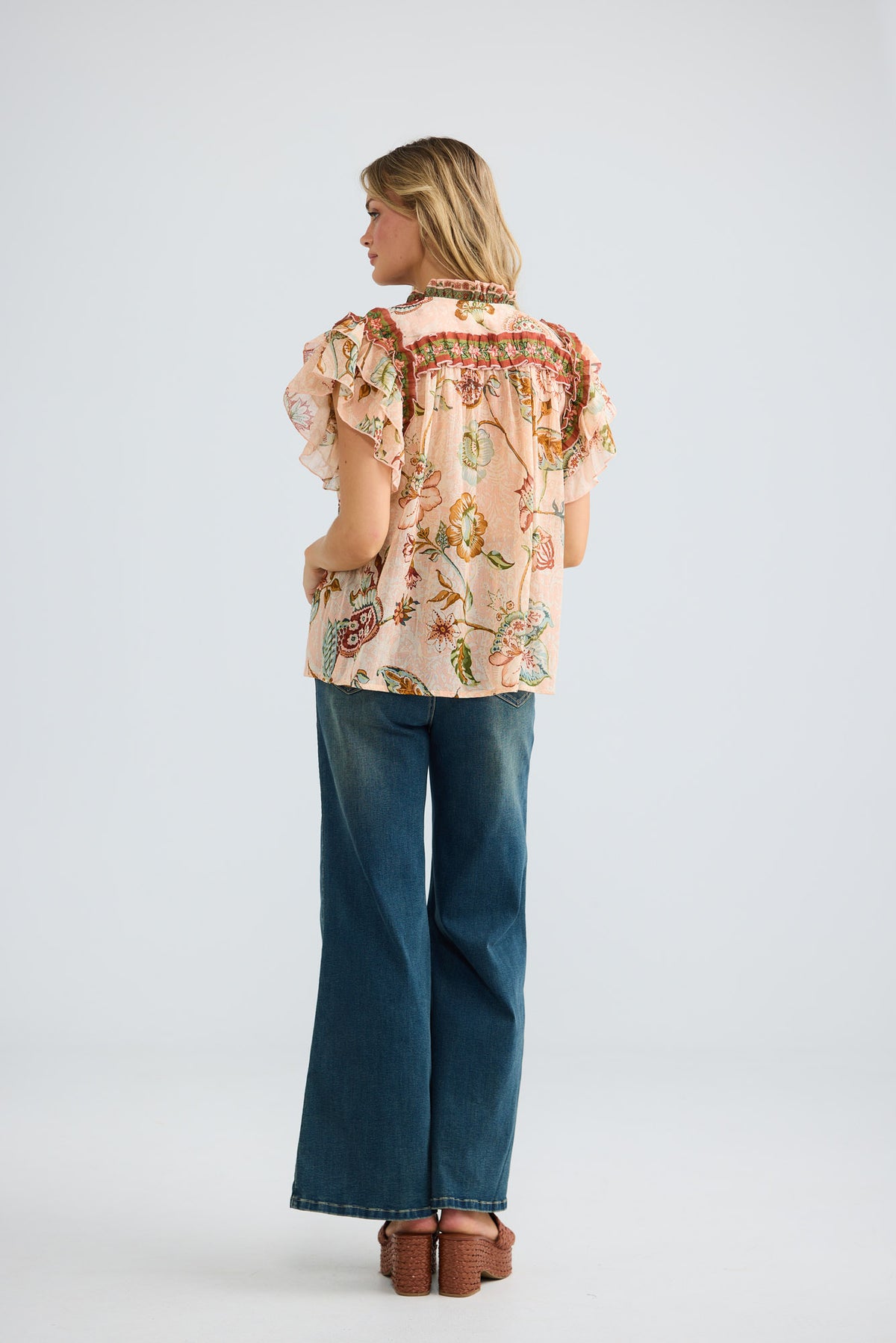 Model wearing Sorrae Top in wildflower oasis, front view.