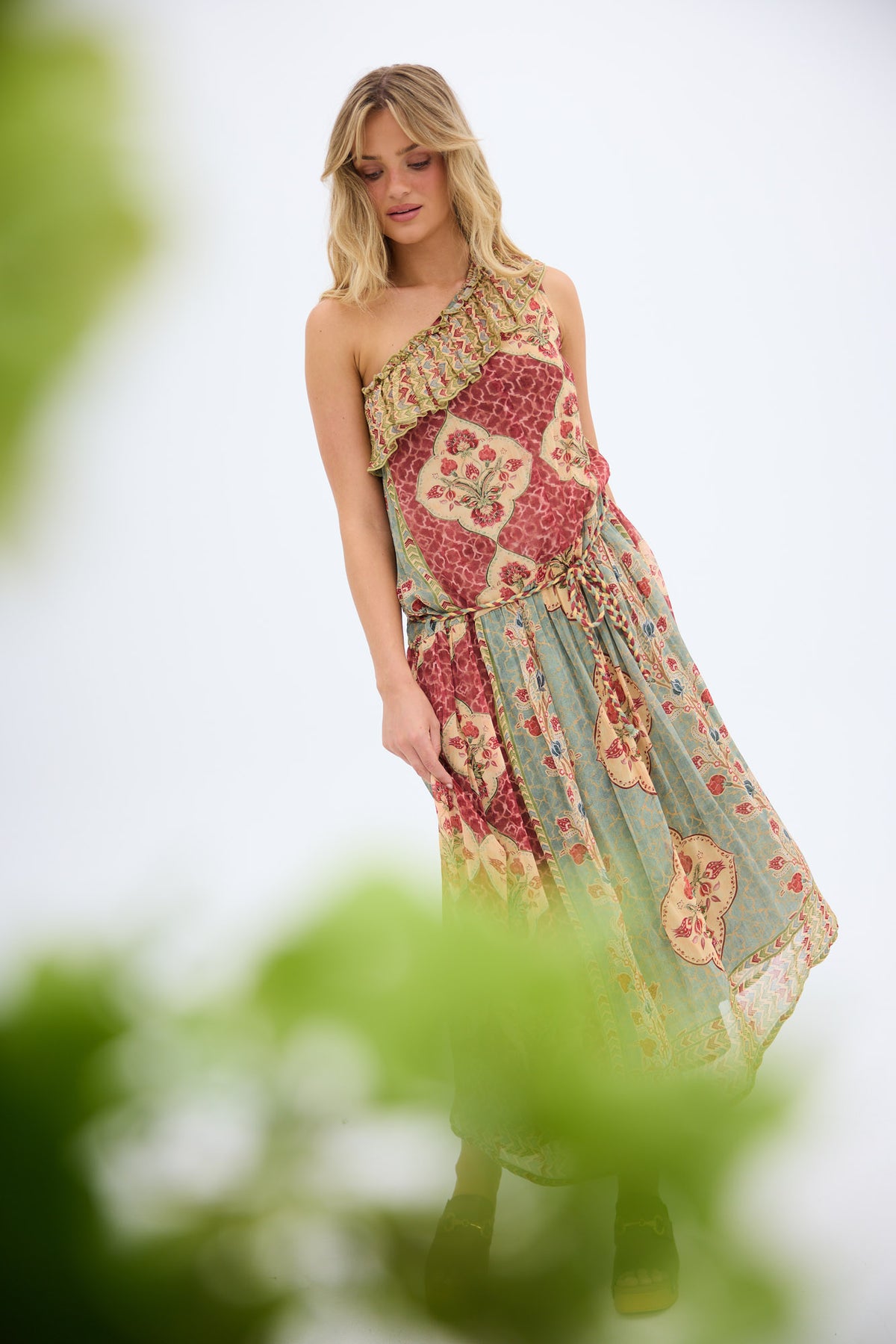 Ravina Dress in garden mist, among soft green foliage.